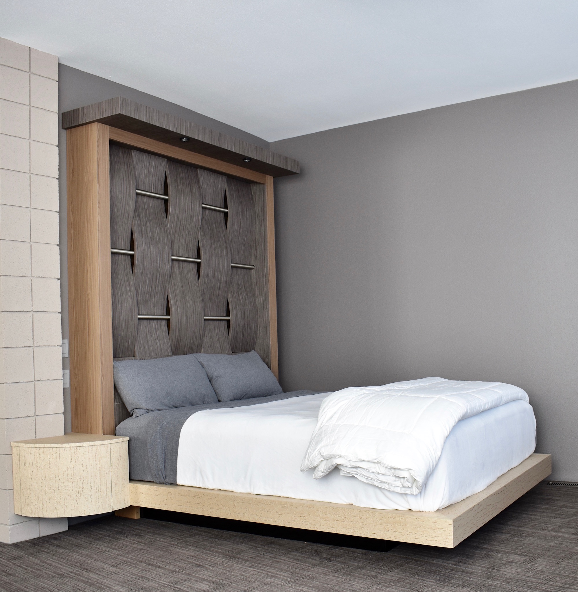 Gray sculptural wave bed by Burkee Designs