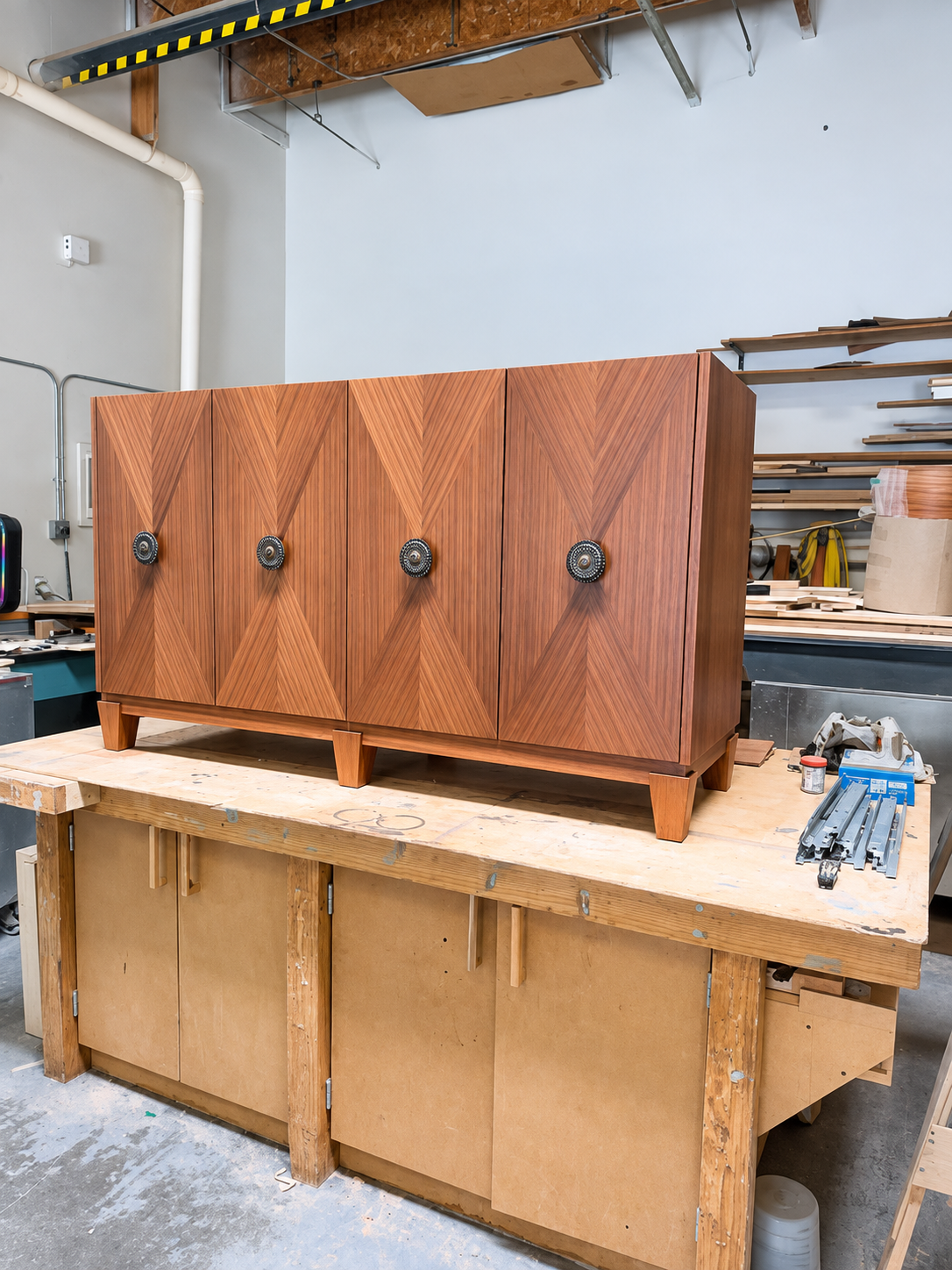 Handcrafted wood cabinet on the workbench inside the Burkee Designs studio
