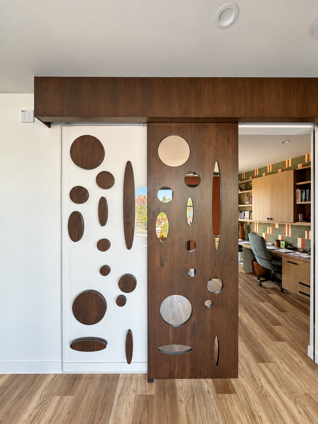 Sliding sculptural screen with circular openings